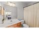 Clean bathroom featuring a single sink, toilet, and shower with curtain at 2319 Alnwick Dr, Duluth, GA 30096