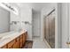 Bright bathroom with double vanity, large mirror, walk-in shower, and tiled floors at 2319 Alnwick Dr, Duluth, GA 30096
