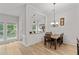 Bright dining area with wood floors and classic chandelier, perfect for Gathering meals and entertaining guests with style at 2319 Alnwick Dr, Duluth, GA 30096