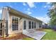 Exterior view of home, showcasing patio, windows, manicured lawn, and wood privacy fence at 2319 Alnwick Dr, Duluth, GA 30096