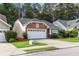 Attractive brick home with well-maintained lawn, two car garage, and lush landscaping, offering great curb appeal at 2319 Alnwick Dr, Duluth, GA 30096
