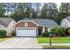 Charming brick home featuring a well-manicured lawn and an attached two-car garage in a beautiful neighborhood at 2319 Alnwick Dr, Duluth, GA 30096