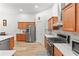 Gourmet kitchen showcasing stainless steel appliances, wood cabinets, and sleek countertops, designed for culinary enthusiasts at 2319 Alnwick Dr, Duluth, GA 30096