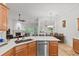 Spacious kitchen with granite countertops, stainless steel dishwasher, and wood cabinets, offering style and functionality at 2319 Alnwick Dr, Duluth, GA 30096