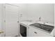 Laundry room featuring a white washer and dryer and a door to an unknown part of the house at 2319 Alnwick Dr, Duluth, GA 30096