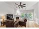 Bright living room featuring wood floors, a fireplace, and large windows, creating a cozy and inviting atmosphere at 2319 Alnwick Dr, Duluth, GA 30096