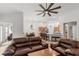 Open-concept living room flowing into the kitchen, featuring hardwood floors and a modern ceiling fan at 2319 Alnwick Dr, Duluth, GA 30096