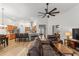 Open-concept living area featuring vaulted ceiling, stylish ceiling fan, and a view into the kitchen at 2319 Alnwick Dr, Duluth, GA 30096