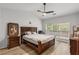 Comfortable main bedroom with a large window, wood floors, and a modern ceiling fan at 2319 Alnwick Dr, Duluth, GA 30096