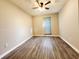 Neutral bedroom features a ceiling fan, laminate floors, and a window with blinds at 2430 Piering Dr, Lithonia, GA 30038