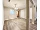 Dining area featuring laminate flooring, neutral walls, ample lighting, and an open layout at 2430 Piering Dr, Lithonia, GA 30038
