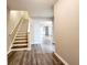 Entryway with laminate flooring, a staircase, and a view of the living room area at 2430 Piering Dr, Lithonia, GA 30038
