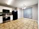 Eat-in kitchen featuring white cabinets, black appliances, tile flooring, and ample natural light at 2430 Piering Dr, Lithonia, GA 30038