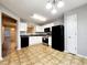 Bright eat-in kitchen with black appliances, white cabinets, and a neutral color scheme at 2430 Piering Dr, Lithonia, GA 30038