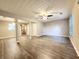 Bright and spacious living room with laminate flooring, a ceiling fan, and natural light at 2430 Piering Dr, Lithonia, GA 30038