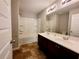 Bathroom features a shower and bath tub combination, double sink vanity, and tiled flooring at 2526 Piering Dr, Lithonia, GA 30038