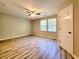 Spacious bedroom featuring wood-look flooring, a ceiling fan, and natural light from two windows at 2526 Piering Dr, Lithonia, GA 30038