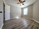 This bedroom includes wood-look floors, a ceiling fan, and a window offering natural light at 2526 Piering Dr, Lithonia, GA 30038