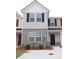 Charming two-story townhome with brick and siding, offering a welcoming front entrance and a well maintained lawn at 2526 Piering Dr, Lithonia, GA 30038