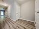 Hallway with wood-look flooring and white paneled doors, offering a bright and clean aesthetic at 2526 Piering Dr, Lithonia, GA 30038