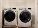 Well-lit laundry room featuring an LG washer and dryer set and white wire shelving above at 2526 Piering Dr, Lithonia, GA 30038