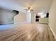 Spacious living room featuring wood-look flooring and access to the kitchen area with dark wood cabinets at 2526 Piering Dr, Lithonia, GA 30038
