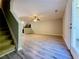 Open living room space featuring wood-look flooring, a ceiling fan, and easy access to the kitchen at 2526 Piering Dr, Lithonia, GA 30038