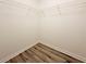 Empty walk-in closet featuring wood-look floors and white wire shelving for plenty of storage at 2526 Piering Dr, Lithonia, GA 30038
