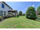 Spacious backyard with lush green lawn, beautiful landscaping, and a covered patio, perfect for outdoor relaxation at 3910 Cameron Ct, Cumming, GA 30040