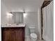 Well-lit bathroom featuring a dark wood vanity, white countertop, and a shower with tiled accents at 3910 Cameron Ct, Cumming, GA 30040