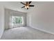 Spacious bedroom featuring large windows providing ample natural light and a ceiling fan at 3910 Cameron Ct, Cumming, GA 30040