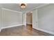 Spacious bedroom with hardwood floors, crown molding, and large doorway leading to another room at 3910 Cameron Ct, Cumming, GA 30040