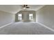 Spacious bonus room featuring plush carpeting, natural light and a ceiling fan at 3910 Cameron Ct, Cumming, GA 30040