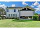 Rear exterior view of the home featuring a covered patio and lush green lawn at 3910 Cameron Ct, Cumming, GA 30040
