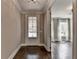 Inviting foyer with hardwood floors and view into the living room with bright natural light at 3910 Cameron Ct, Cumming, GA 30040