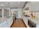 Modern kitchen with white cabinets, stainless steel appliances, and granite countertops at 3910 Cameron Ct, Cumming, GA 30040