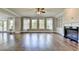 Large living room with hardwood floors, fireplace, built-in cabinets, and large windows for lots of light at 3910 Cameron Ct, Cumming, GA 30040