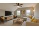 Inviting living room with a large TV, comfortable seating, and plenty of natural light at 3910 Cameron Ct, Cumming, GA 30040