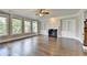 Spacious living room with fireplace, built-in shelving, hardwood floors, and bright natural light at 3910 Cameron Ct, Cumming, GA 30040