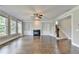 Open living room with hardwood floors, built-in shelving, a fireplace, and ample natural light at 3910 Cameron Ct, Cumming, GA 30040