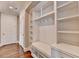 Bright mudroom featuring built-in storage, shelving, hooks, and a cushioned bench at 3910 Cameron Ct, Cumming, GA 30040