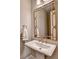Stylish powder room with a unique gold mirror and modern fixtures at 3910 Cameron Ct, Cumming, GA 30040
