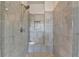 Modern walk-in shower featuring light-colored, marble-look tile and a built-in niche at 3910 Cameron Ct, Cumming, GA 30040