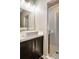 Bathroom featuring modern vanity, square sink, framed mirror, vanity lighting, and glass door shower at 472 Martin Se St # 10, Atlanta, GA 30312