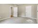 Neutral bedroom with carpet, baseboard trim, neutral paint, and two white paneled doors at 472 Martin Se St # 10, Atlanta, GA 30312