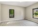 Neutral bedroom with carpet, neutral paint, baseboard trim, and a black window with neighborhood view at 472 Martin Se St # 10, Atlanta, GA 30312