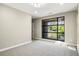 Neutral bedroom with carpet, neutral paint, baseboard trim, and a large window with neighborhood view at 472 Martin Se St # 10, Atlanta, GA 30312