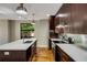 Kitchen with a large island, modern appliances, dark wood cabinets, and gleaming hardwood floors at 472 Martin Se St # 10, Atlanta, GA 30312