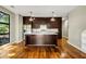 Spacious kitchen features an island, stainless steel appliances, and gleaming hardwood floors at 472 Martin Se St # 10, Atlanta, GA 30312