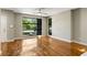 Living room with hardwood floors, ceiling fan, neutral paint, and a large window overlooking the neighborhood at 472 Martin Se St # 10, Atlanta, GA 30312